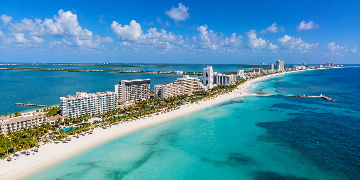Northern Cancun Hotel Zone beach curving toward the sheltered Bahia de Mujeres with calmer water
